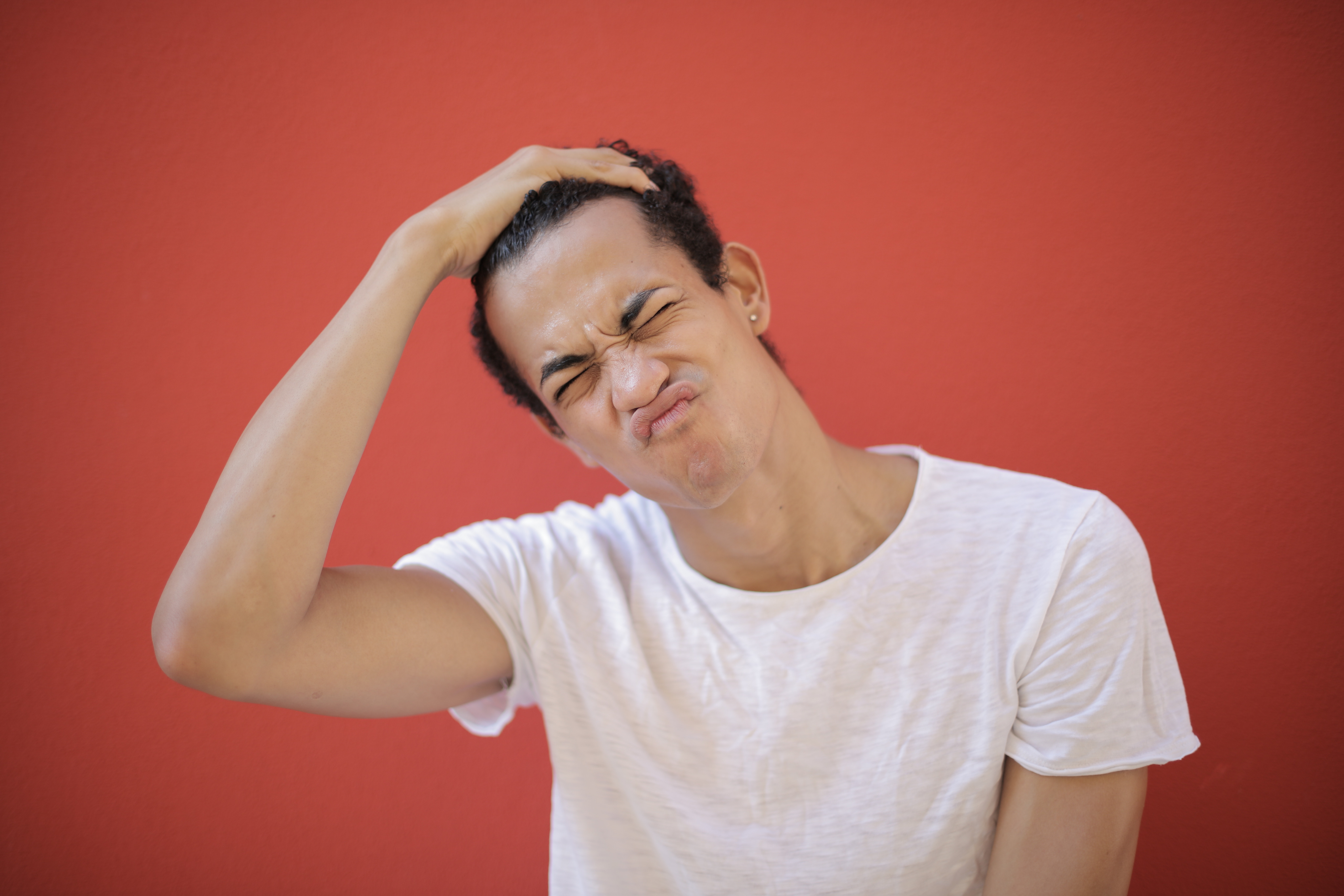 young-displeased-man-with-piercing-making-face-3799787