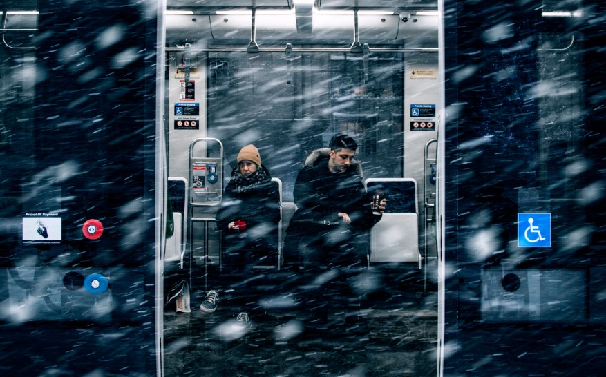 man-beside-woman-in-train-1970830